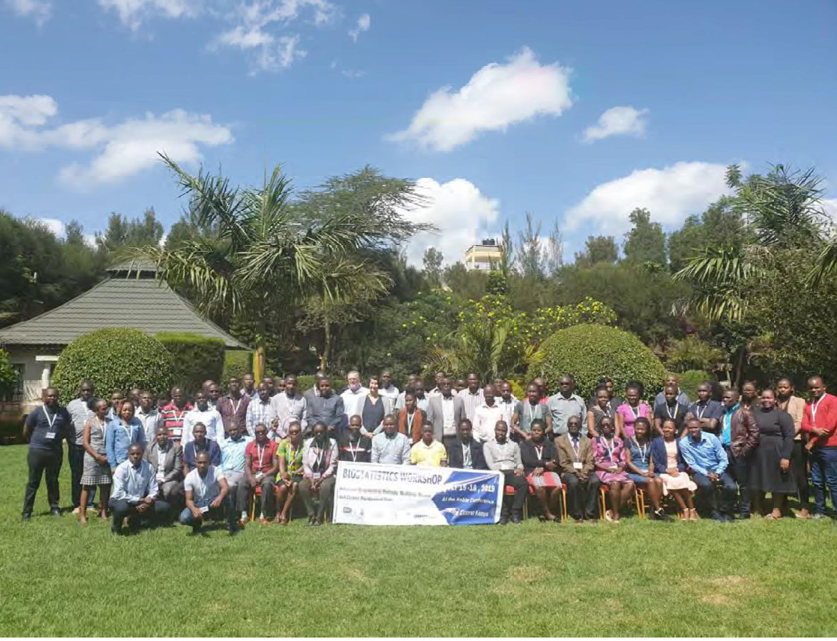 Group shot of Kenyan workshop attendees outside conference center in Eldoret, Kenya on a sunny day on the lawn.