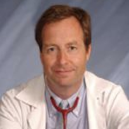 Headshot of Dr. Timothy Flanigan. He is wearing a lab coat and a stethoscope.