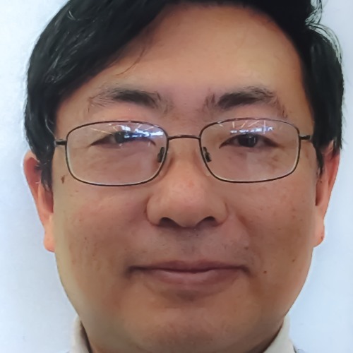 Portrait of Dr. Jie Tang in a white turtleneck 