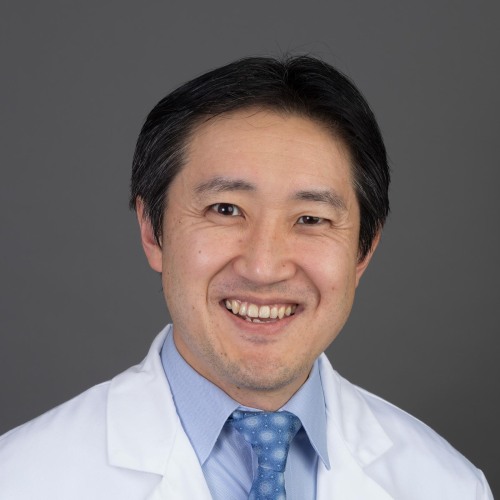 Photo of Taro Minami in a white lab coat