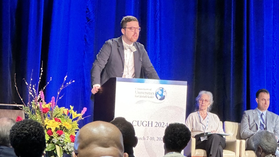 Dylan Bush making acceptance speech at CUGH conference